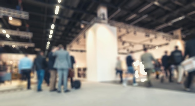 blurred people moving, standing and walking on trade show booths. ideal for websites and magazines layouts