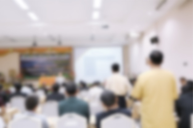 Blurred people presenting in large conference room