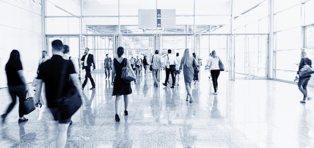 Blurred people at a trade fair hall