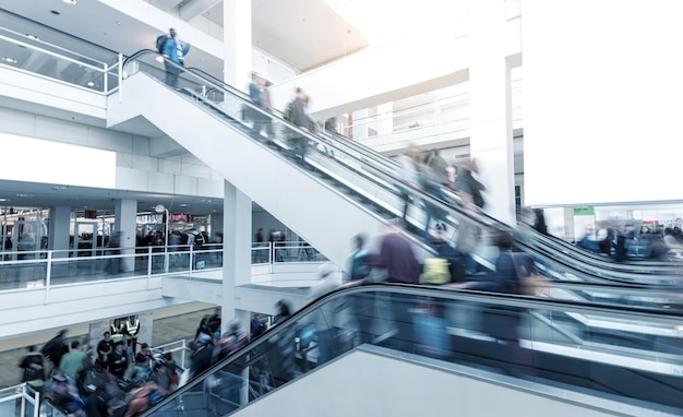 Blurred people using a escalator on a International Trade Fair