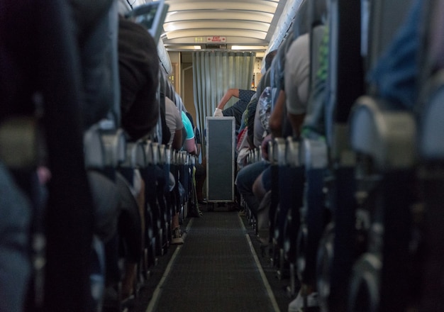 Photo blurred photo of the aircraft interior. passengers in the cabin airplane