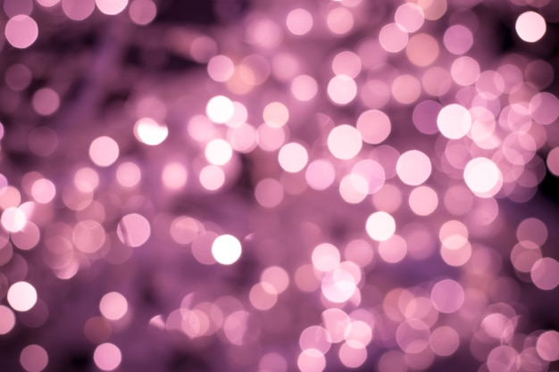 Blurred pink backdrop, night bokeh lights texture, defocused background. Illuminated blurry backgrounds with shiny circles.