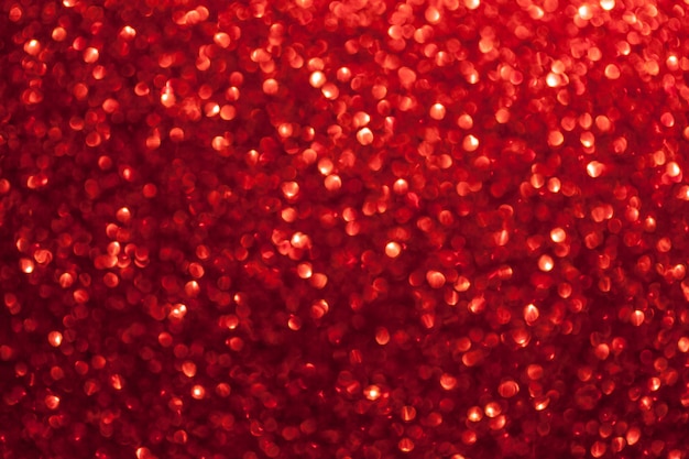 Blurred shiny red background with sparkling lights.