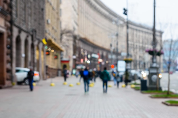 Blurred silhouettes of different people in a crowded street