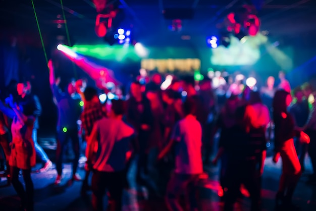 Blurred silhouettes of people dancing in a nightclub