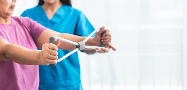 Blurred soft images of Physical therapist doing and using equipment to support arm muscles