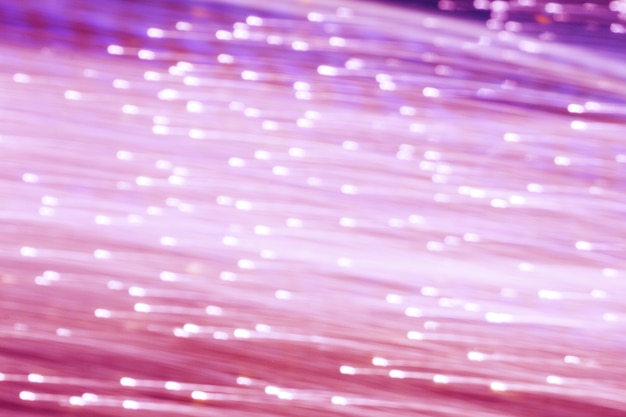 Blurred sparking many pink and purple color light moving horizontal on black background