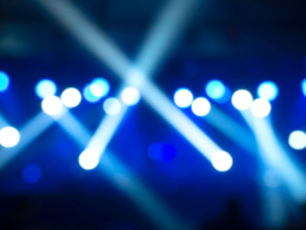 Blurred stage light concert background with blue color beam and laser rays on stage