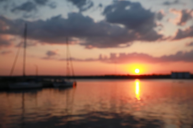 Blurred view of river pier at sunset