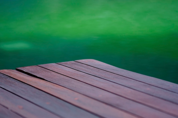 Blurred wood floor with green blurred pattern background