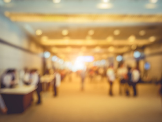 Blurry background of exhibition expo with crowd people in convention hall