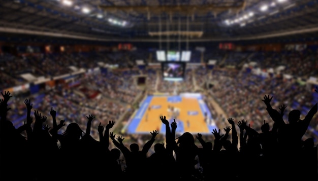 Blurry basketball stadium with public celebration