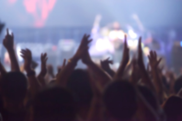 blurry image background of many audience concert in big rock concert.