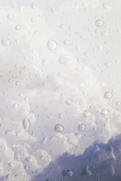 Blurry storm clouds seen through wet window on a rainy day