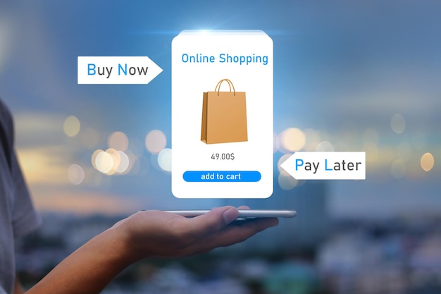 BNPL Buy now pay later online shopping conceptHands holding mobile phone on blurred city as background