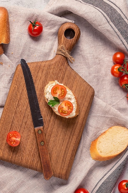 Board bread and tomatoes for making sandwiches