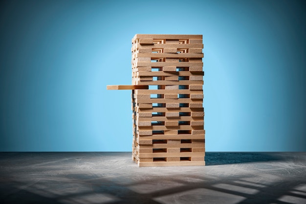 Board game jenga, a tower of wooden blocks on blue