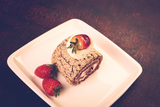 Board with delicious cake on table