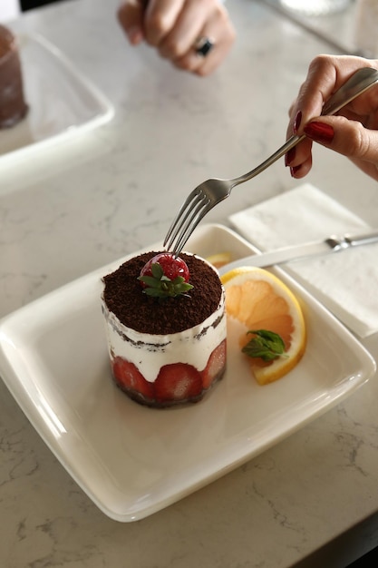 Board with delicious cake on table