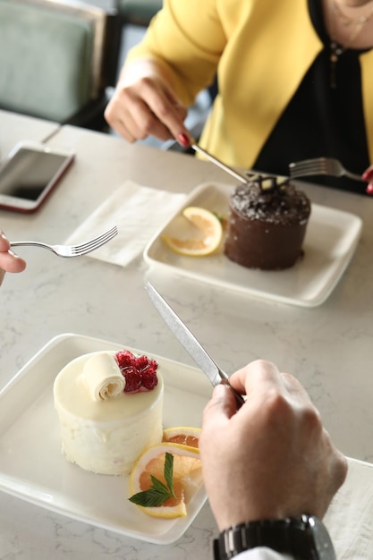 Board with delicious cake on table