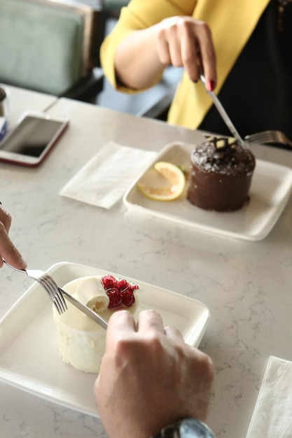 Board with delicious cake on table