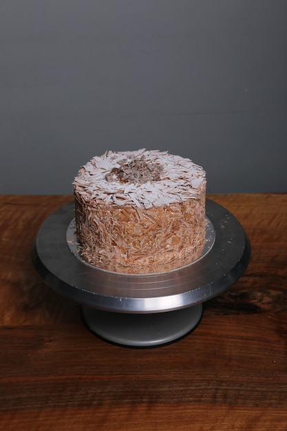 Board with delicious cake on table