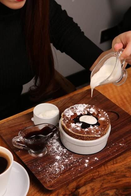 Board with delicious cake on table