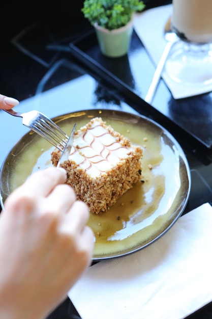 Board with delicious cake on table