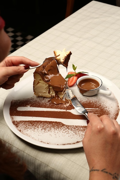 Board with delicious cake on table