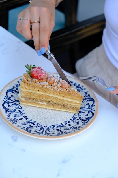 Board with delicious cake on table