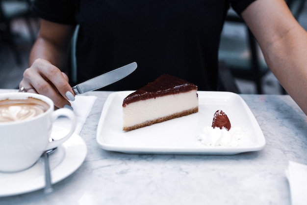 Board with delicious cake on table