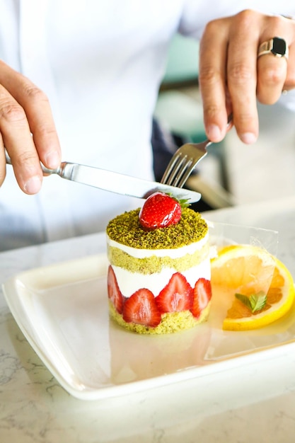 Board with delicious cake on table