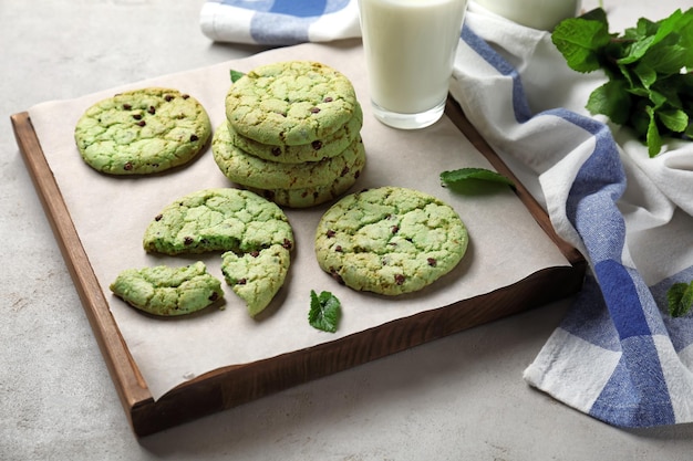 Photo board with mint chocolate chip cookies on table