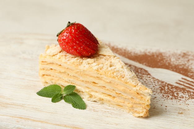 Board with piece of Napoleon cake with strawberry