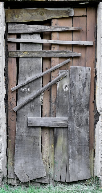 Boarded up wooden door to an old abandoned house