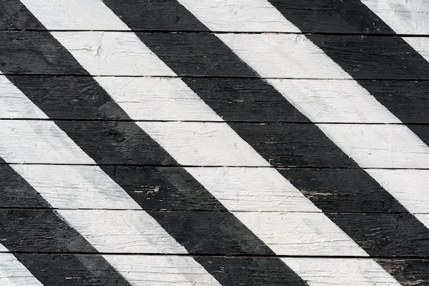 Boards are painted with black and white paint diagonally Abstract background