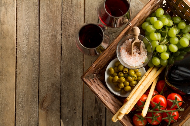 Boards with wine glasses and basket full of healthy products