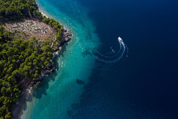 boat on bird's eye view of beautiful coastline Makarska riviera in Dalmatia Croatia