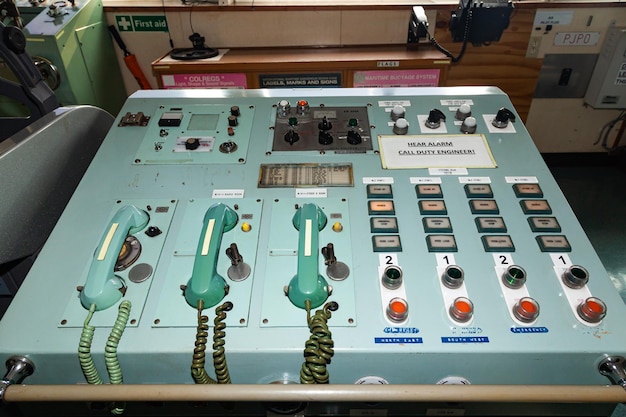 Boat control panel with analog corded telephones buttons switches and warning lights