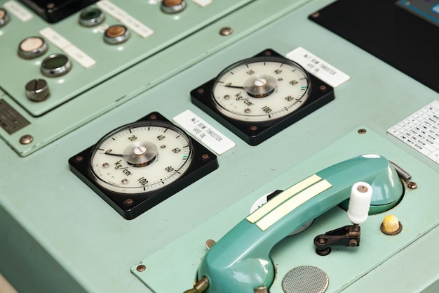 Boat control panel with analog corded telephones buttons switches and warning lights