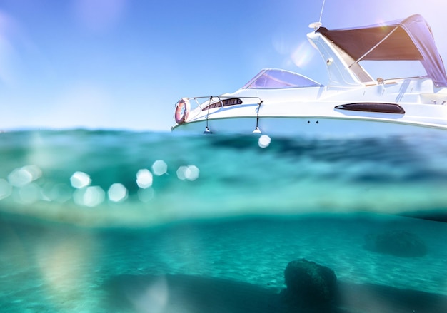 Boat floats in a crystalline and transparent sea