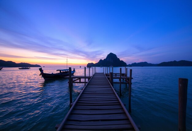 a boat is docked at a dock with a mountain in the background