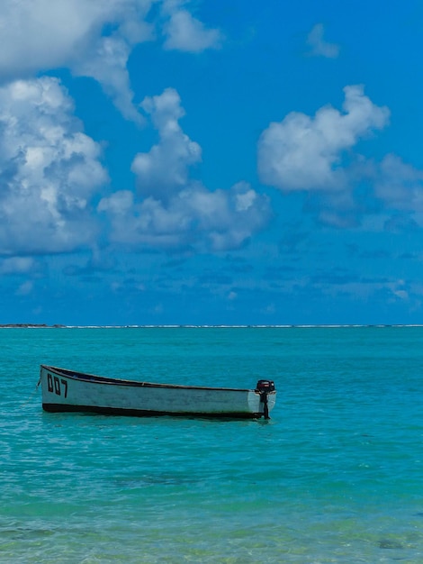 Boat in the middle of the ocean clear turquoise water in Mauritius