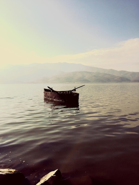 Boat moored in river against sky