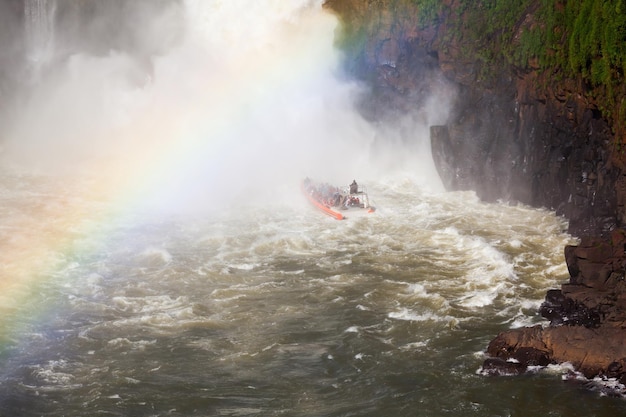 Boat near the Iguazu Falls (Cataratas del Iguazu), waterfalls of the Iguazu River on the border of the Argentina and the Brazil.