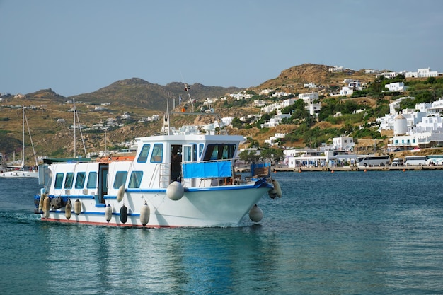 Boat in port harbor of Chora town on Mykonos island Greece