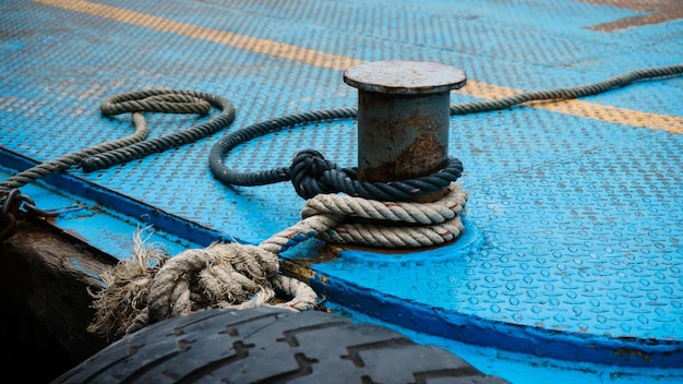 Boat rope tied up on a bitt Large steel bollard at the harbour