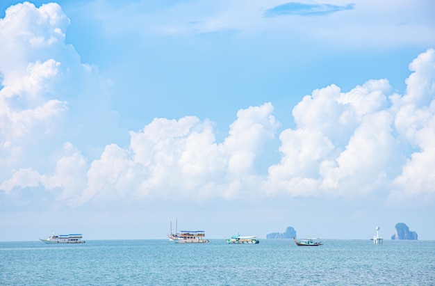 Boat tours in the sea  background Island and clouds on the sky  at Krabi in Thailand.