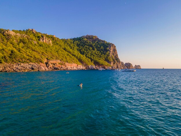 A boat in the water with a mountain in the background