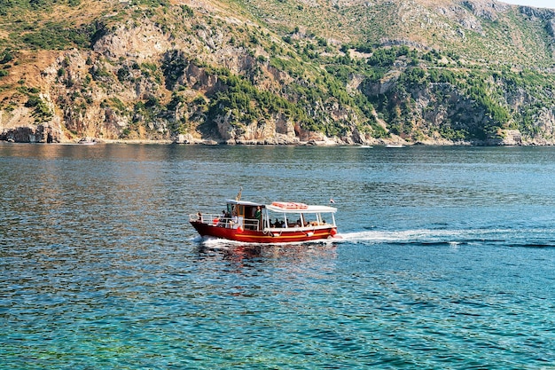 Boat with people at Lokrum Island of Adriatic Sea in Dubrovnik, Croatia